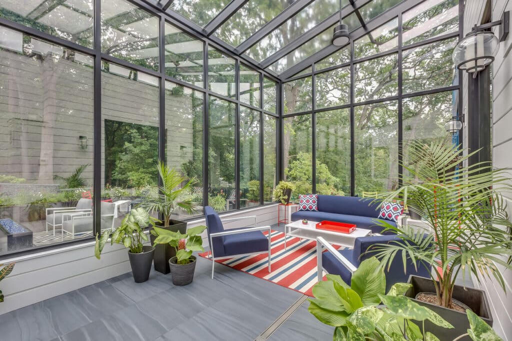Huge luxurious sunroom with green plants and other bright colors