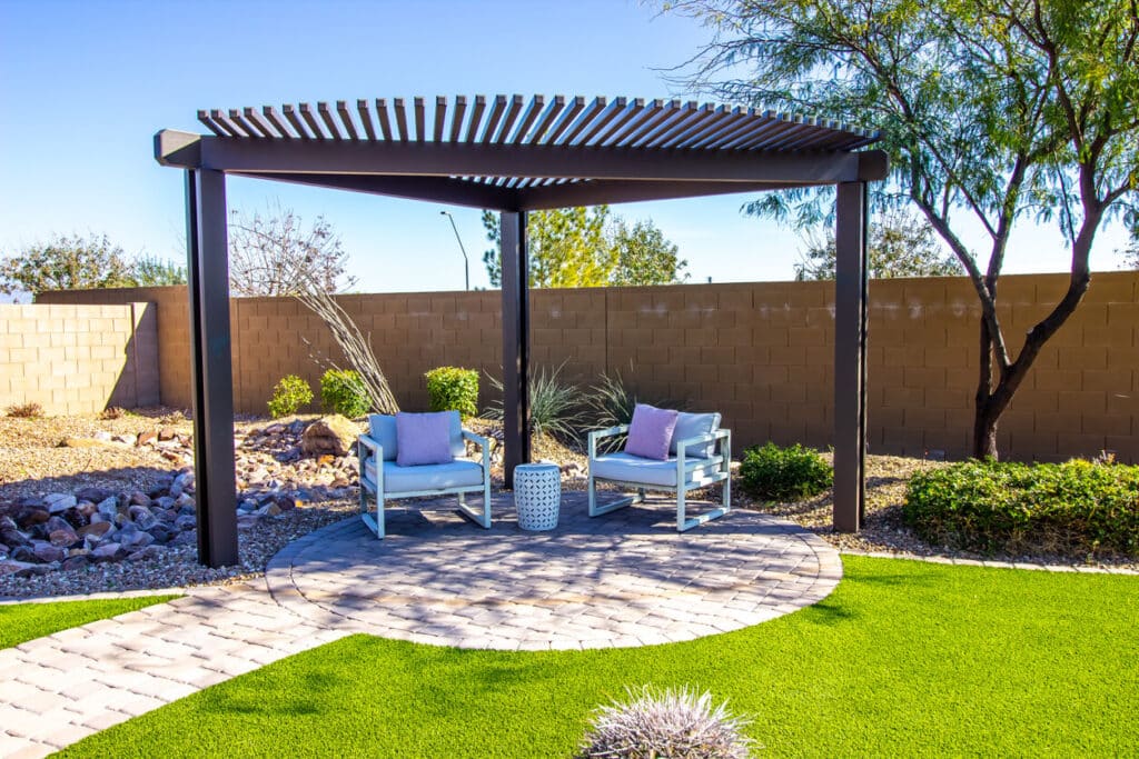 Pergola With Two Arm Chairs On Pavers Patio.