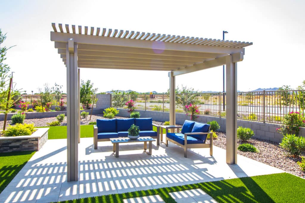 Rear Yard Pergola Covering Patio Furniture.